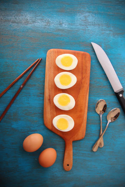istock boiled egg garnish with avocado, tomato on blue wooden background 1127825642