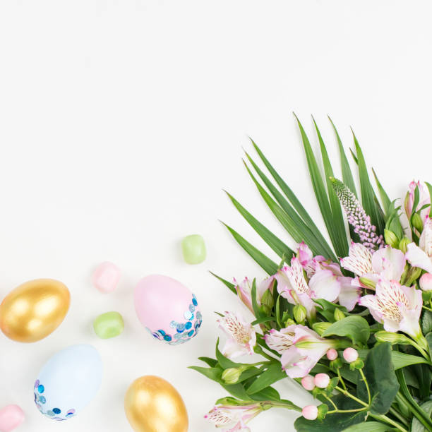 istock Festive Happy Easter background with decorated eggs, flowers, candy and ribbons in pastel colors on white. Copy space 1127827390