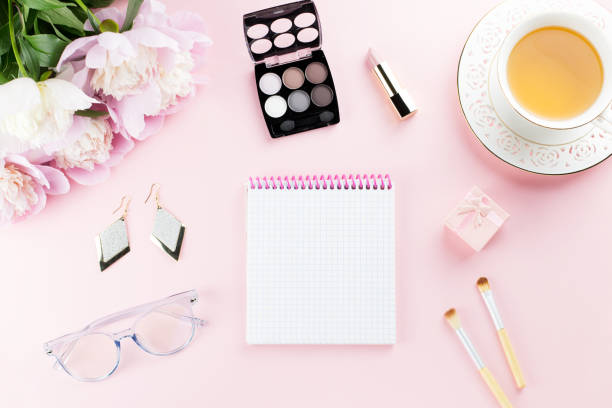 istock Beautiful cosmetics and flowers flat lay with note book, herbal tea on pastel background. 1127827541