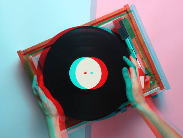 istock Female hands  use retro vinyl player on a blue pink pastel background. DJ. Top View 1127832080