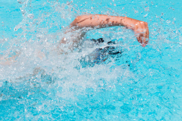 istock Swimmer in the open air swimming pool. 1127833537