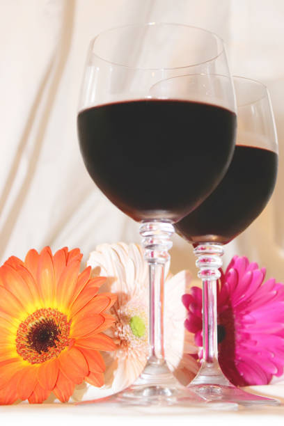 istock red wine in glasses and flowers. selective focus. 1127833678