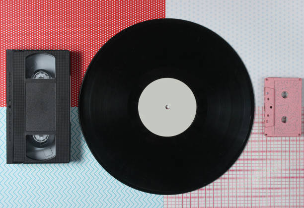 istock Video cassette, vinyl record, audio cassette on a creative background, top view 1127834923