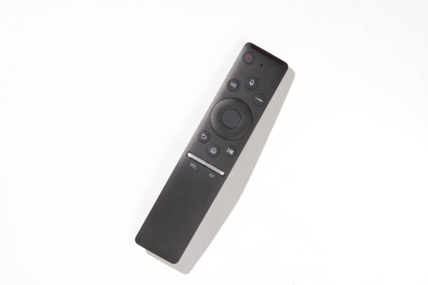 istock Modern tv remote on a white background. Photo with shadows, hard light, top view 1127836286