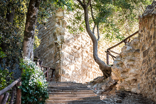 Castiglione del Lago, Italy Fortress stone steps stairs in Umbria Rocca with Medievale o Rocca del Leone and nobody low angle looking up by garden park