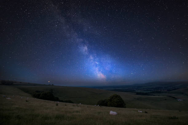 istock Vibrant Milky Way composite image over landscape of Steyning Bowl on South Downs 1127837729