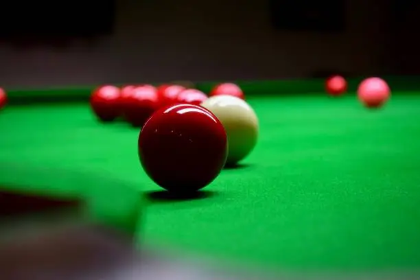 A snooker game with a red ball ready to be played