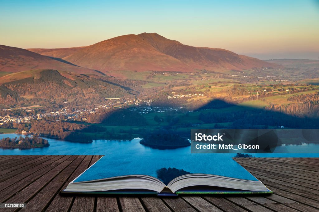 Beautiful late afternoon Autumn Fall landscape image of the view from Catbells near Derwent Water in the Lake District coming out of pages of open story book Stunning late afternoon Autumn Fall landscape image of the view from Catbells near Derwent Water in the Lake District coming out of pages of open story book Autumn Stock Photo