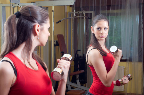 istock Woman exercising at home 1127838811