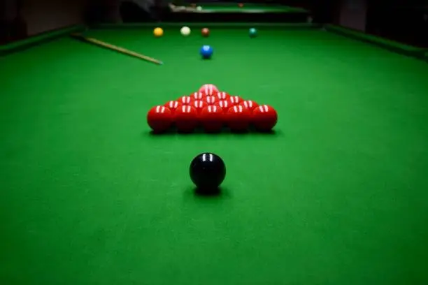 Built up snooker table before kick-off with all colors (yellow, green, brown, blue, pink, black) on their spots and the red balls in the triangle