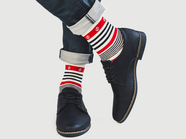istock Men's legs, bright socks with and shoes 1127840549