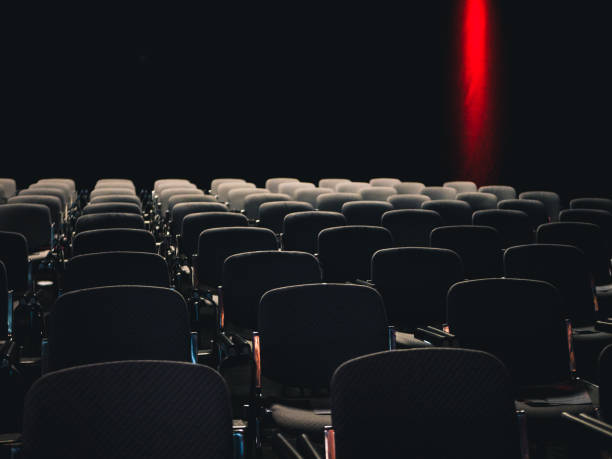 istock Empty seats in a dark room at a business conference 1127841592