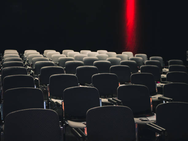 istock Empty seats in a dark room at a business conference 1127841627