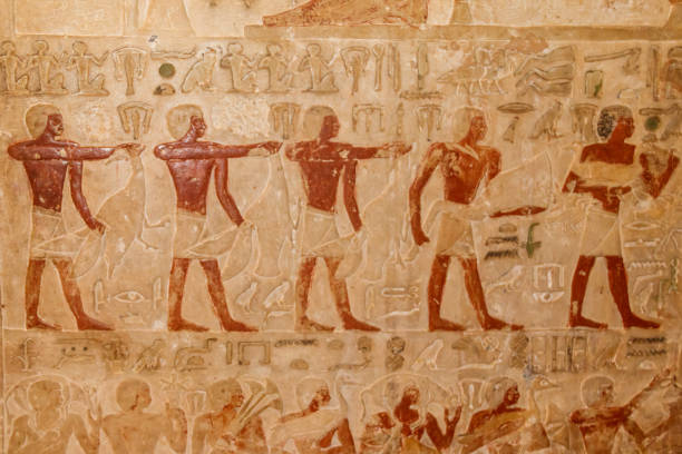 istock Ancient egyptian paintings and hieroglyphs carved on the stone wall 1127841797
