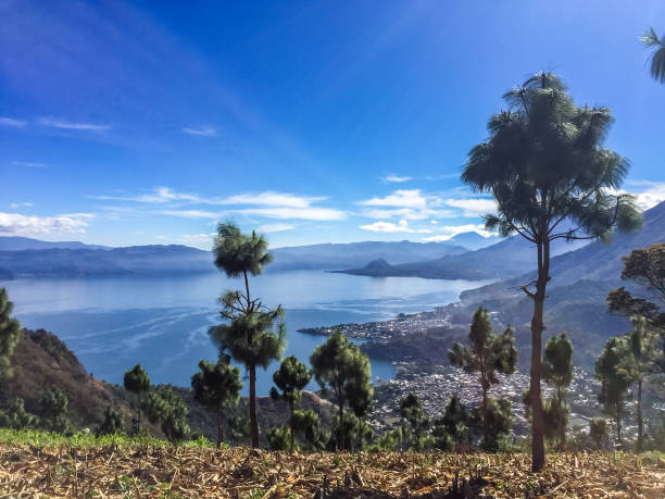 Young woman on the lakeshore, volcano view, Guatemala