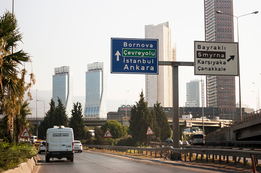 Folkart Towers and Ege Perla tower on the scene with traffic and information road signs.