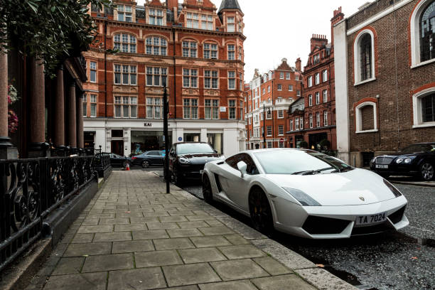 White Lamborghini Murcielago parked on London city street London, UK - 5 February, 2019: color image depicting a white Lamborghini Murcielago sports car parked on the city street in Mayfair, one of the most exclusive and luxurious parts of London. Room for copy space. Mayfair stock pictures, royalty-free photos & images