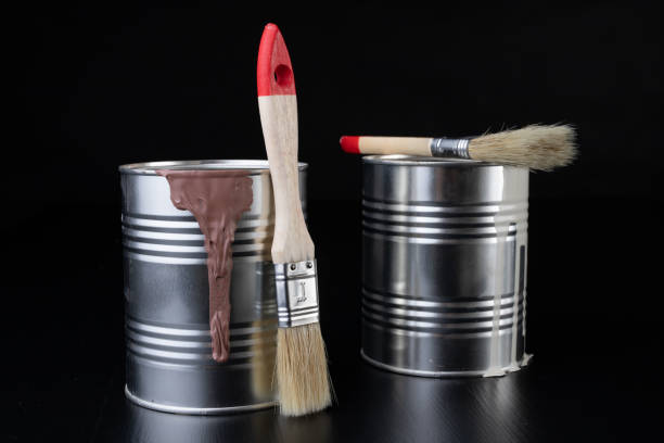 istock Brushes for painting with paint and cans on a workshop table. Painting accessories prepared for painting. 1127847906