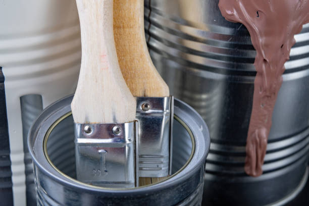istock Brushes for painting with paint and cans on a workshop table. Painting accessories prepared for painting. 1127849627