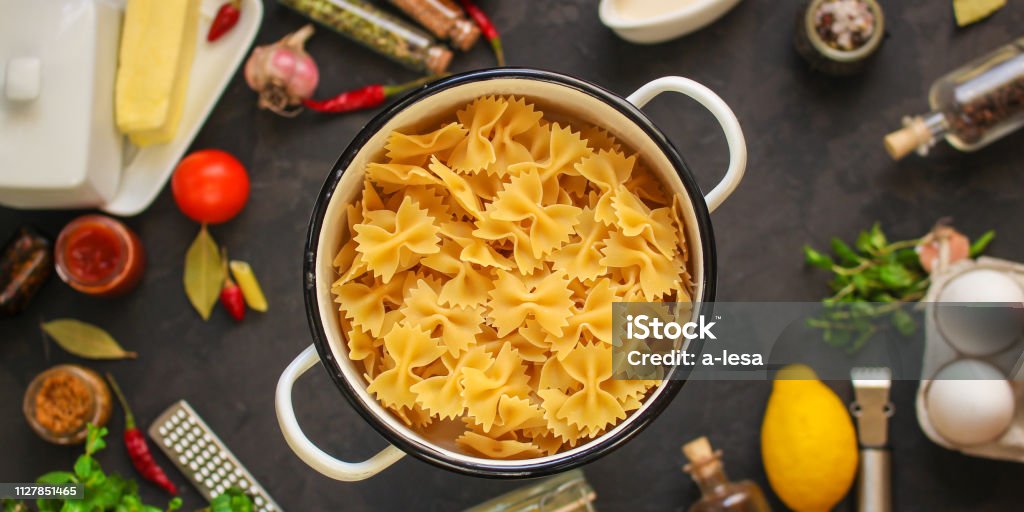 pasta, farfalle and sauce (set of ingredients). food background. copy space pasta, farfalle and sauce (set of ingredients) Backgrounds Stock Photo