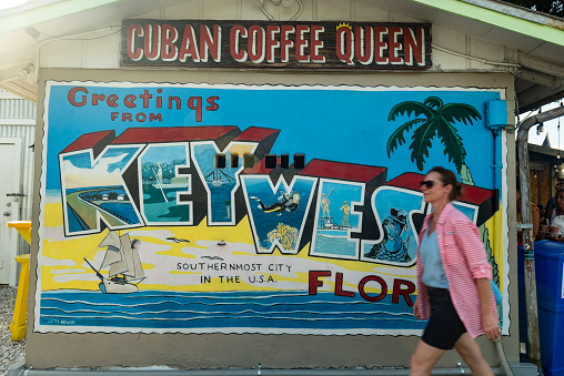 Key West, Florida, United States - August 15, 2018: Image of a woman walking on the streets downtown in Key West, Florida Keys - United States