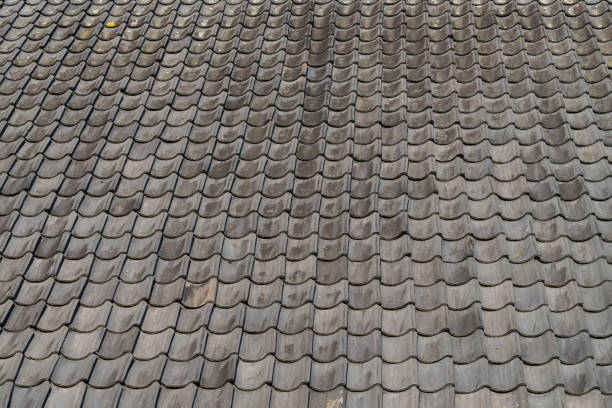 istock Grey roof tiles close up and full frame in rows 1127852122