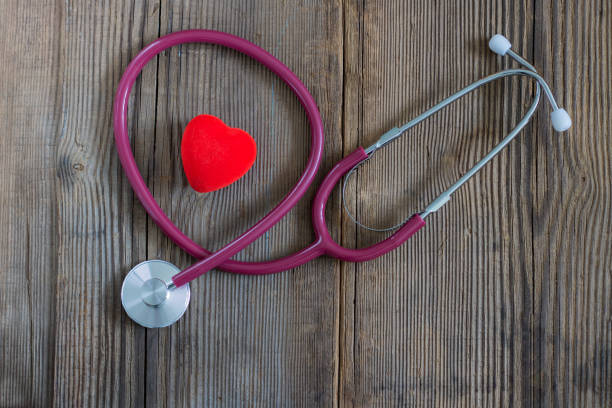istock Red heart and a stethoscope on the old wooden desk. Horizontal 1127852906