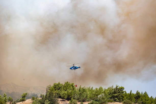 istock Helicopter carrying water tank for fire fighting 1127853498