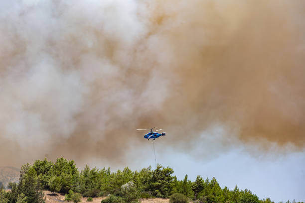 istock Helicopter carrying water tank for fire fighting 1127853624