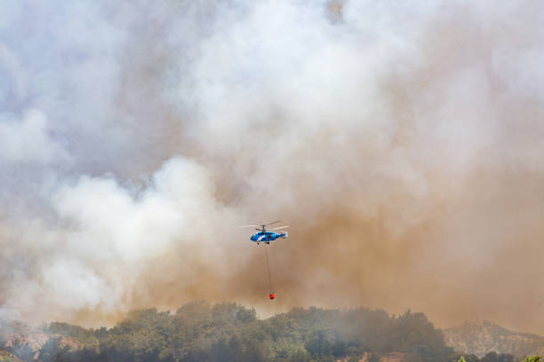 istock Helicopter carrying water tank for fire fighting 1127854098