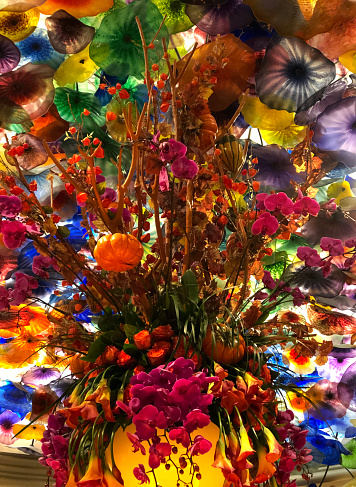 A colorful bouquet of flowers surrounded by blown glass