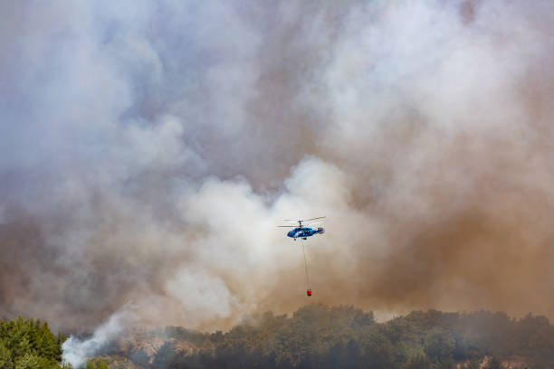 istock Helicopter carrying water tank for fire fighting 1127854206