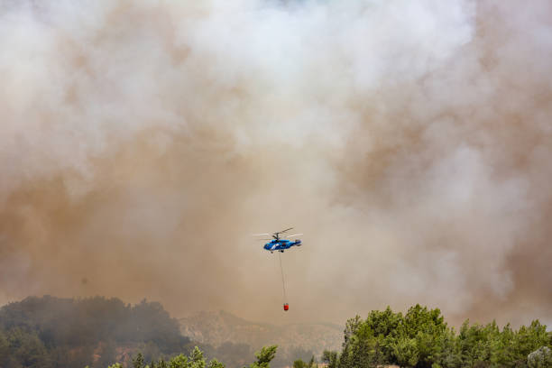 istock Helicopter carrying water tank for fire fighting 1127854243