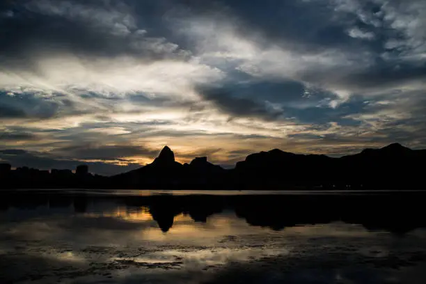 Sunset on the Rodrigo de Freitas Lagoon in the southern zone of Rio de Janeiro, Brazil attracts tourists from all over the world and locals to watch this spectacle of nature