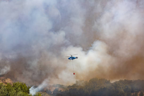 istock Helicopter carrying water tank for fire fighting 1127854890