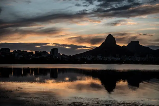 Sunset on the Rodrigo de Freitas Lagoon in the southern zone of Rio de Janeiro, Brazil attracts tourists from all over the world and locals to watch this spectacle of nature