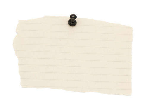 Blank paper notes are pinned to a cork board. The concept of detective investigation. Copy space