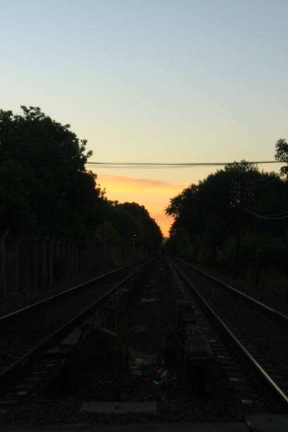 istock VIEWS OF TRAIN TRACK IN FRONT WITH SUNSET IN THE BACKGROUND 1127857413