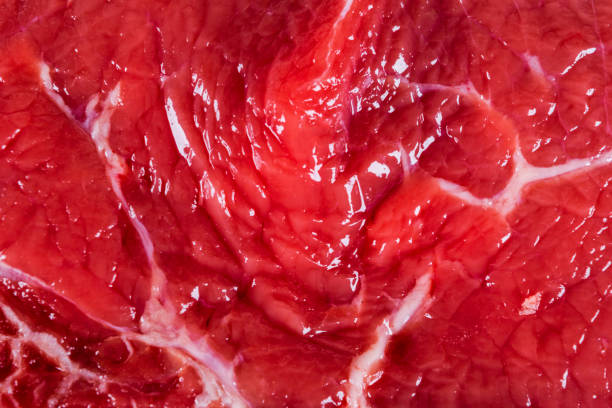 istock Beef raw red meat closeup texture background. Fresh beef piece in closeup. Marbled meat texture. Raw fillet of beef steak. 1127858699