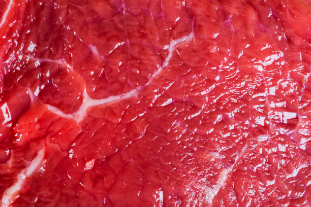istock Beef raw red meat closeup texture background. Fresh beef piece in closeup. Marbled meat texture. Raw fillet of beef steak. 1127858760