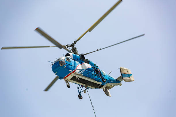 istock Helicopter carrying water tank for fire fighting 1127859688