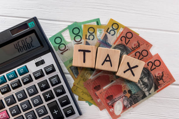 istock Australian dollar banknotes with wooden cubes and calculator 1127863945