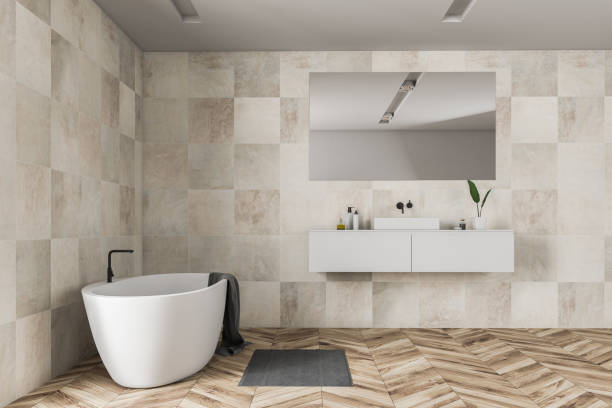 istock Beige tile bathroom interior, tub and sink 1127866268
