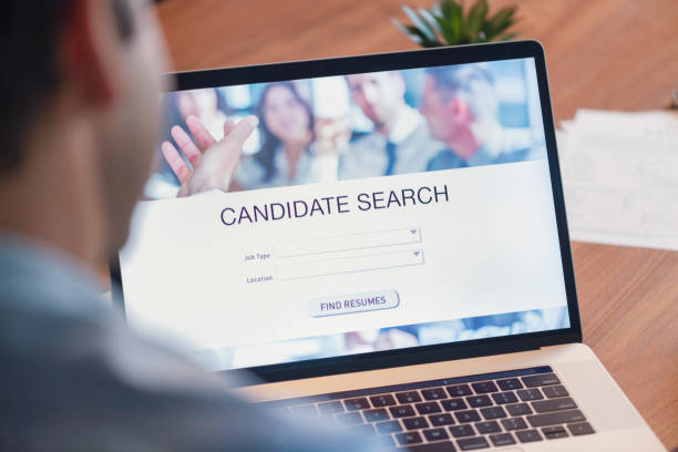 istock Businessman looking at recruitment website on a laptop computer. 1127866563