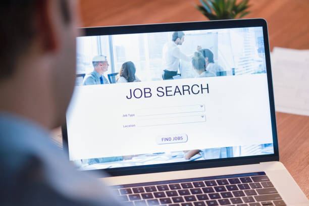 istock Businessman looking at job search website on a laptop computer. 1127866571