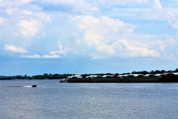 istock Tug boat and barge with pleasure boat 1127867615