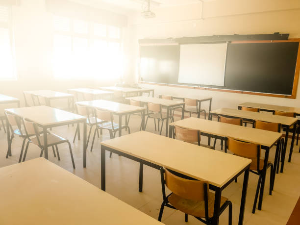istock School classroom in blur background without young student; Blurry view of elementary class room no kid or teacher with chairs and tables in campus. 1127868553