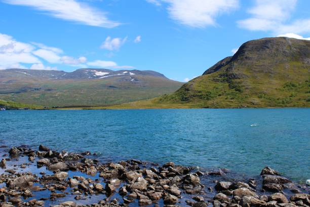 istock Blue lake with mountains in the background 1127871352