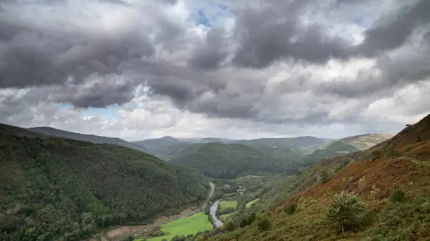 Beautiful landscape image of view from Precipice Walk in Snowdonia overlooking Barmouth and Coed-y-Brenin forest during rainy afternoon in September