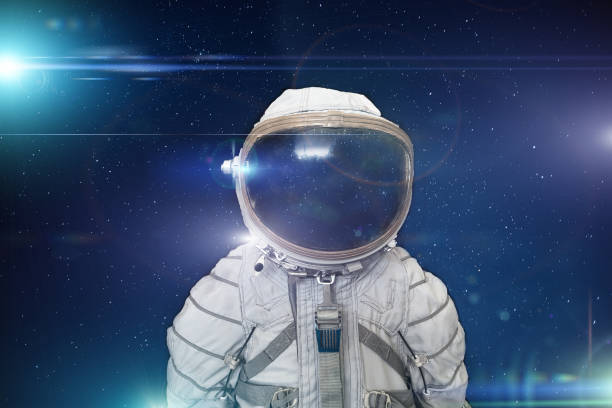 istock Retro cosmonaut or astronaut or spaceman with helmet on space with stars and blue light effects background, abstract science fiction concept 1127871455
